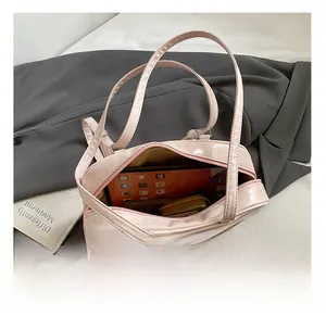 Detail view of the large capacity interior of this pink patent leather tote bag for women
