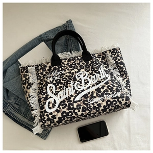 Detail of leopard print canvas tote bag featuring fringe trim and Saint Barth logo design