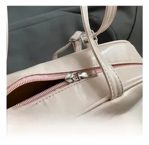 Close-up of high-quality silver zipper hardware on pink bow fashion backpack