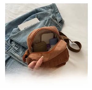 Internal capacity of the brown corduroy crossbody bag with daily items inside