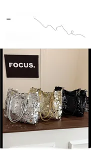Detail shot of shimmering sequin texture on shoulder bags in silver gold and black