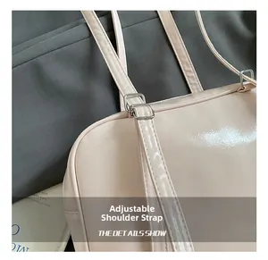 Detailed close-up of the metal adjustable strap buckle on a pink bow backpack