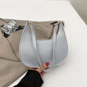 Metallic silver minimalist crescent crossbody bag with textured finish and top handle