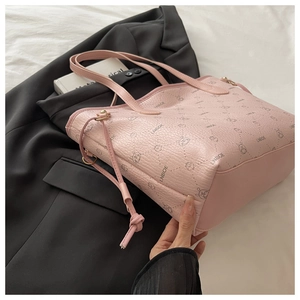 Detail of pink faux leather tote bag with rabbit patterns and long tassel drawstring