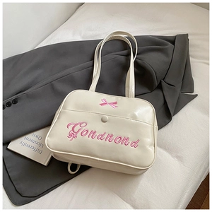 Detail of cream PU tote bag with pink Gonamond embroidery and a sweet ribbon bow
