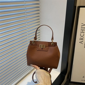 Classic brown lychee pattern leather handbag with gold twist lock and top handle