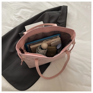 Pink tote bag interior showing capacity for tablets, books, and daily essentials