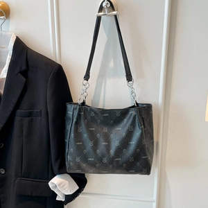 Elegant black embossed leather tote bag with pattern and silver metal chain strap