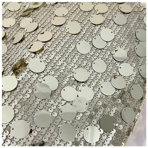 Macro shot of tiered champagne gold sequins on a stylish shoulder tote bag