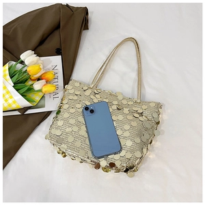 Detailed view of a gold sequin tote bag with a smartphone to demonstrate the large capacity