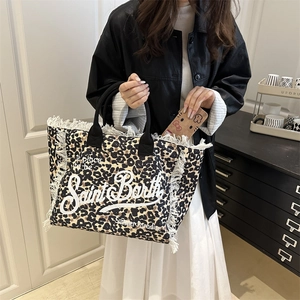 Saint Barth leopard print tote bag with white fringes and black handles on a model