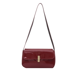 Retro red patent leather shoulder bag with sleek gold buckle for a minimalist chic look