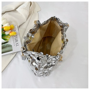 Top view of silver sequin bag showing magnetic closure and champagne fabric lining