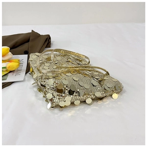 Detail of gold sequin tote bag with hanging circular discs and slim shoulder strap