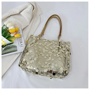 Detail of shimmering gold sequin tote bag showing metallic texture and sequined charm