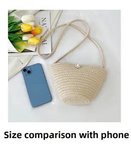 Detail view of woven bucket bag next to a smartphone showing compact internal capacity