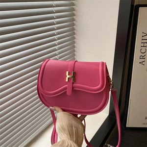 Chic pink saddle bag with golden H-buckle hardware and adjustable leather shoulder strap