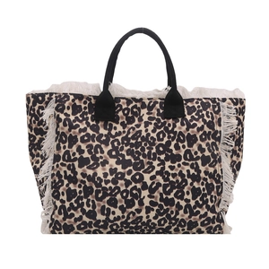 Chic leopard print tote bag with white tassel trim and black handles on white background