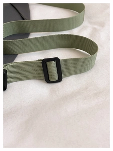 Detail of durable green nylon shoulder strap with black adjustable plastic buckle