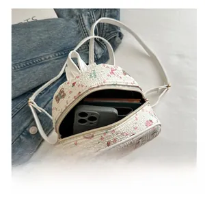 Top view of mini floral backpack interior showing storage capacity and phone compartment