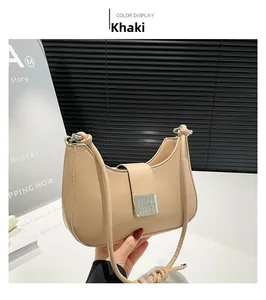 Detail of khaki crescent shoulder bag with knotted strap and silver metallic clasp
