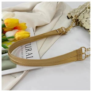 Detailed shot of golden PU leather shoulder strap with metallic chain on sequined bag