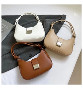 Detail showing high-quality leather bags with metal buckles and twisted knot handles