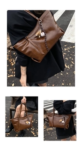Detail of dark brown oil wax leather tote bag featuring a sporty baseball glove charm