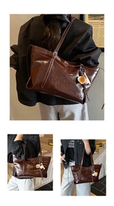 Detail of dark brown crinkled leather tote bag with unique baseball glove charm