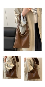 Detail of a brown leather tote bag with silver studs and spacious shoulder strap design