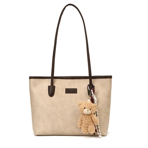 Large beige tote bag with brown straps and cute bear pendant for daily commuting