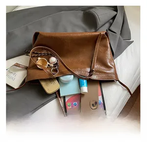 Spacious interior of brown pleated leather tote bag showing high storage capacity