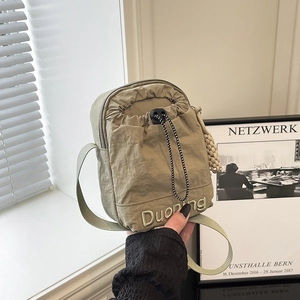 Nylon drawstring crossbody bag in khaki featuring a front logo embroidery and strap