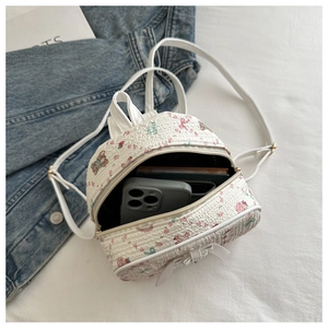 Detail of floral mini backpack showing interior capacity with a smartphone inside