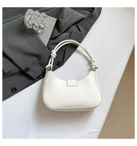 Close-up of a white hobo bag with unique twisted rope handle and minimalist smooth finish