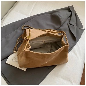 Spacious interior of camel suede tote with grey lining, zip pocket and gold chain strap