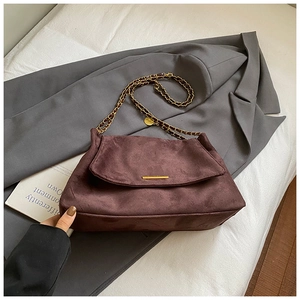 Deep burgundy suede tote bag with gold metal bar detail and leather chain strap detail