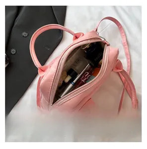 Pink Boston handbag interior view showing storage capacity for cosmetics and skincare