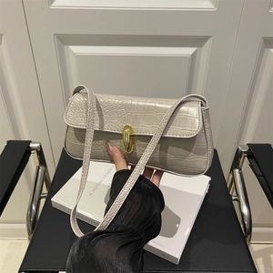 Minimalist beige crocodile embossed shoulder bag with elegant gold rotary clasp lock