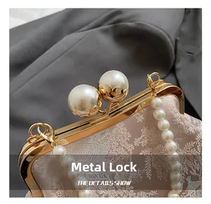 Close-up of golden metal frame with large pearl clasps and jacquard fabric detail