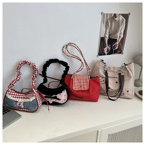 Detailed display of assorted canvas tote bags featuring plaid patterns and bow decorations