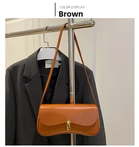 Detailed view of the brown retro shoulder bag with a gold metal clasp and elegant leather texture