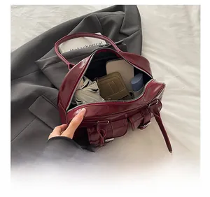 Interior view of burgundy leather shoulder bag showing ample storage and multiple pockets
