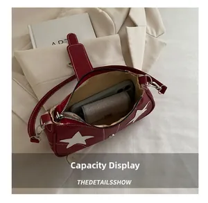 Top view of star-patterned burgundy shoulder bag showing inner capacity for phone and wallet