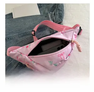 Interior view of pink floral canvas waist bag showing space for phone and wallet