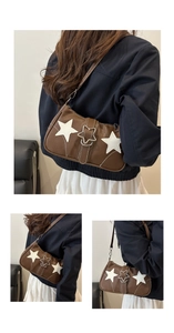 Close-up of vintage brown leather underarm bag with unique star-shaped metal buckle