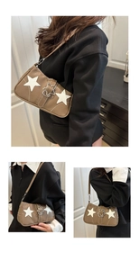 Close-up of brown textured leather shoulder bag with white star patches and star buckle