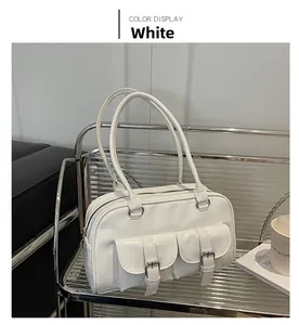 Polished white bowling bag detail featuring dual buckle front pockets on a modern shelf