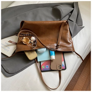 Interior view of caramel brown tote bag showing spacious capacity for tablets and daily items