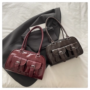 Close-up of gloss finish leather textures and metal buckle details on retro Boston bags